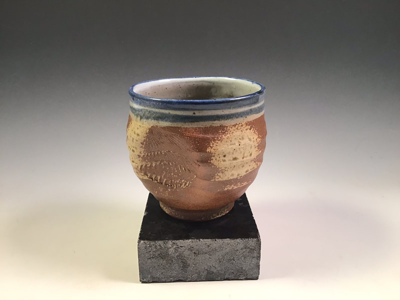 Tea bowl with shell impression, wood ash spray and cobalt blue lines. Cone 10 in propane reduction. Signed.
$68 includes shipping to L48.
 Contact Simon at: simonleachpottery@gmail.com